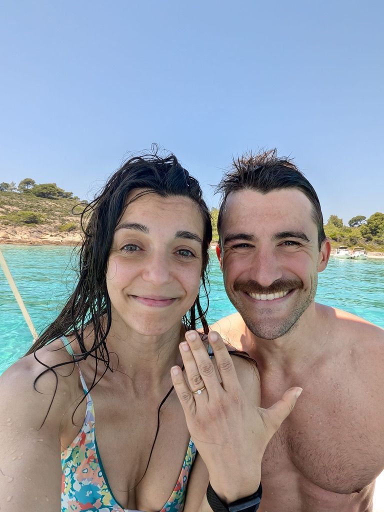 Anastasia showing her engagement ring on a boat